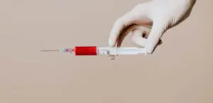 A syringe filled with a red fluid.