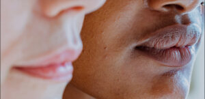 A close up photo of two people's lower half of the face.