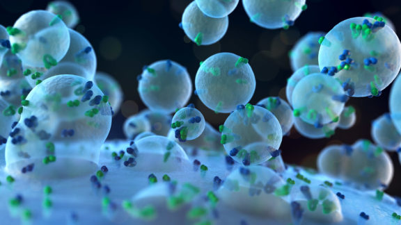 A computer render of exosomes entering a cell.
