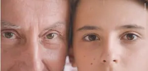 A close photo of two faces of different age.