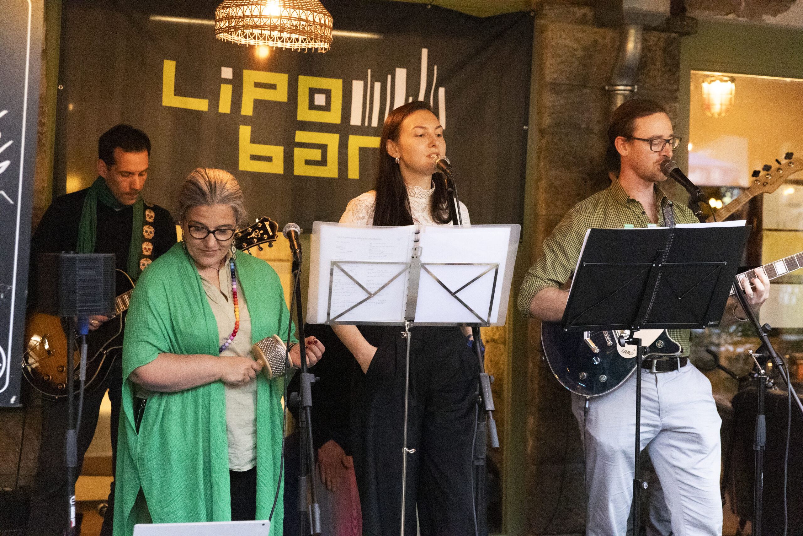 people singing and playing music in a band