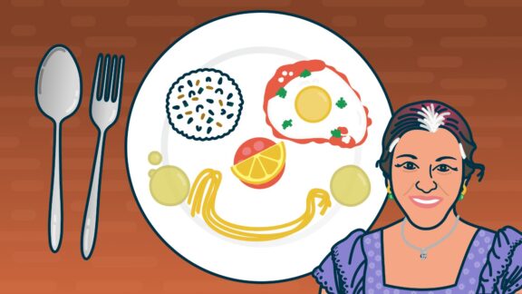 A dish on a table and a woman smiling