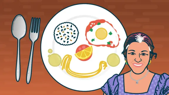 A dish on a table and a woman smiling