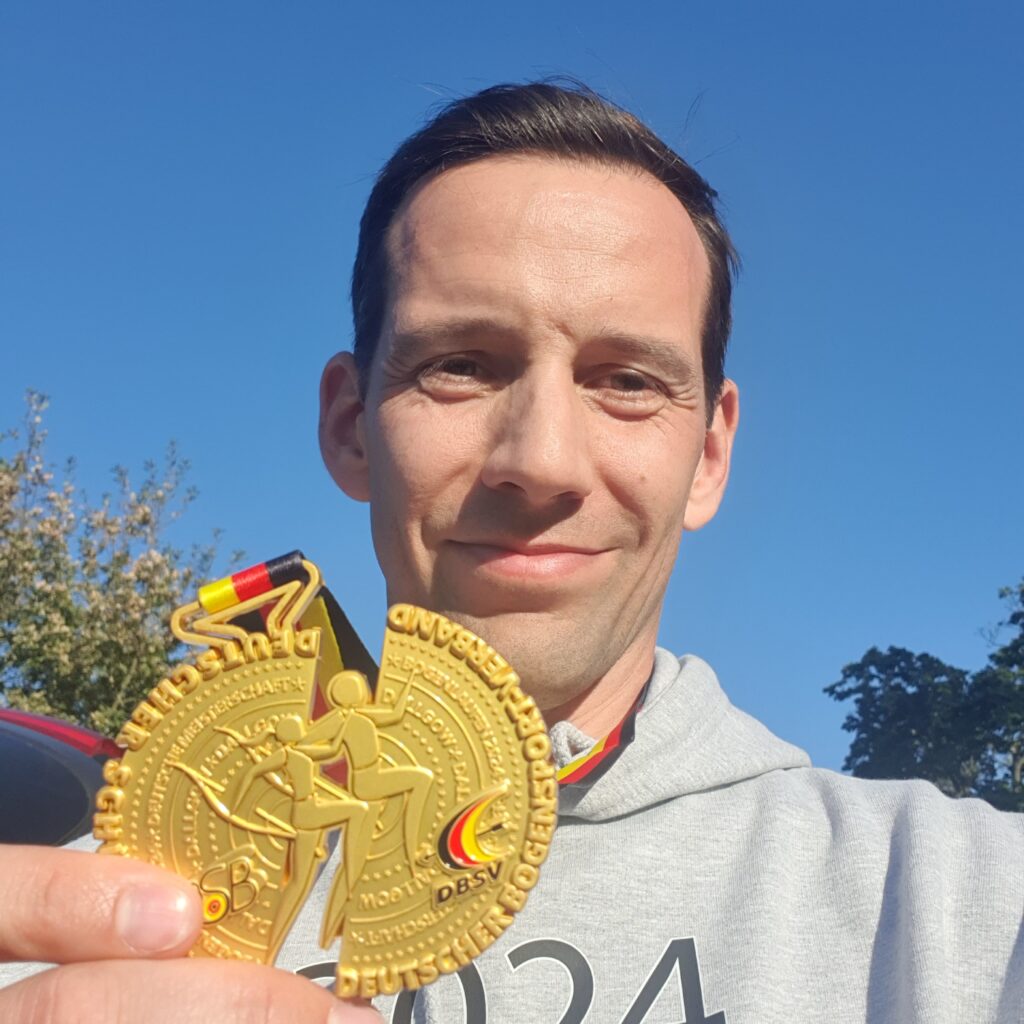 A man holding a medal